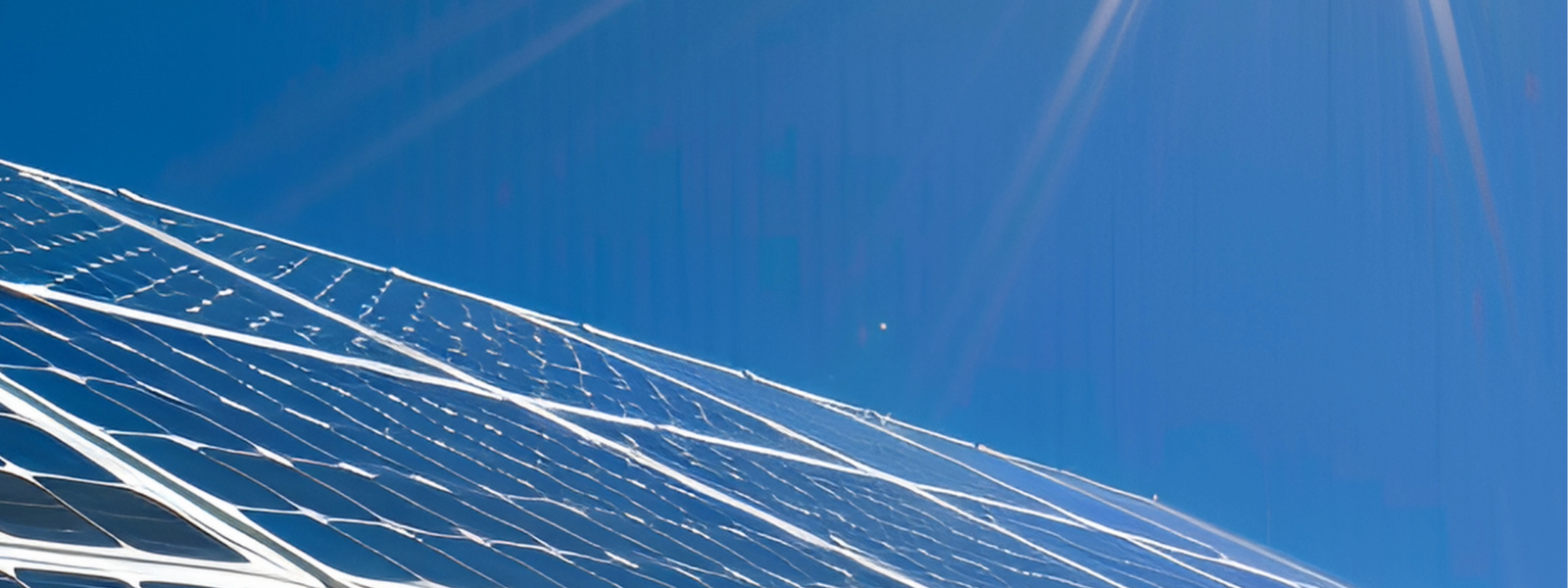 Bild på solceller på tak och en sol som lyser på dem